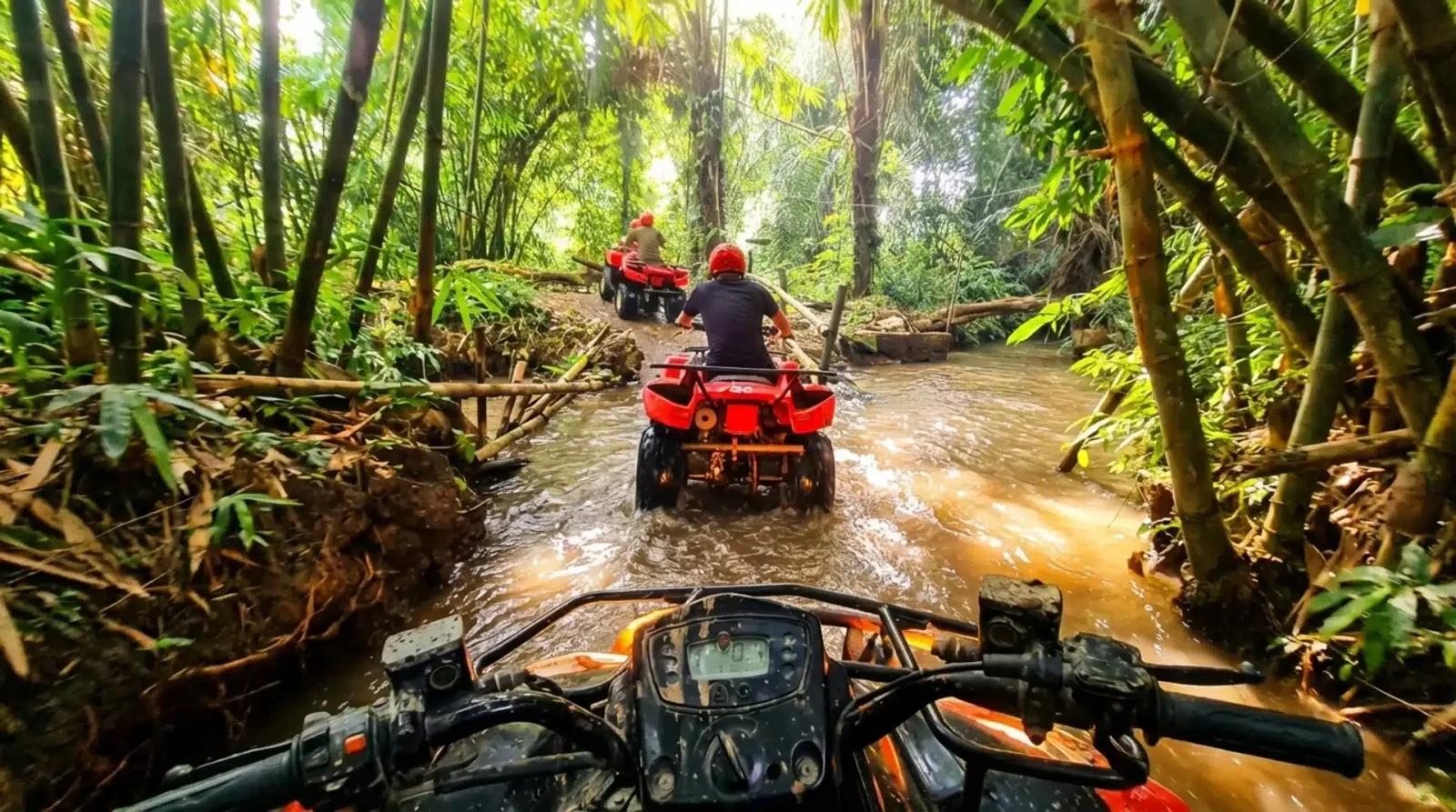 ATV riders crossing a muddy jungle river surrounded by bamboo and dense tropical foliage