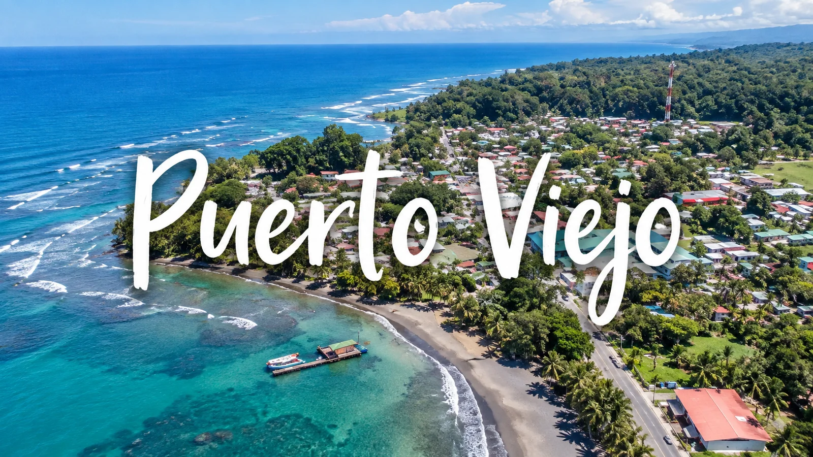 Aerial view of Puerto Viejo, Costa Rica with coastal town, beach, reef and coastline text overlay