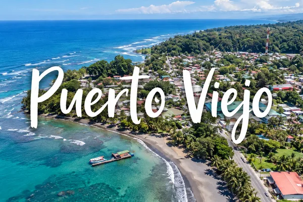Aerial view of Puerto Viejo, Costa Rica with coastal town, beach, reef and coastline text overlay
