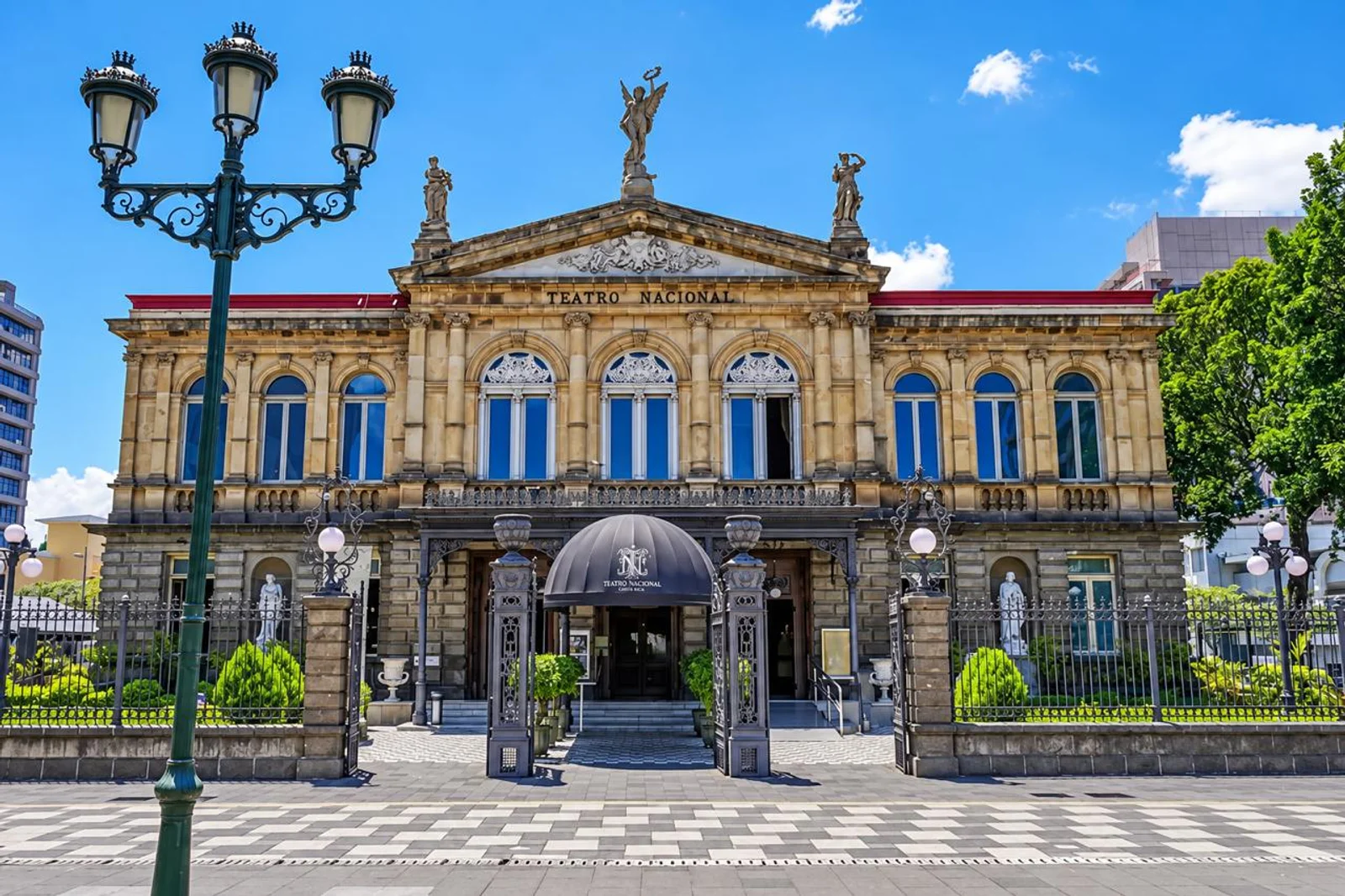 Teatro Nacional de Costa Rica facade in San Jose, with ornate statues, columns and an ironwork entrance