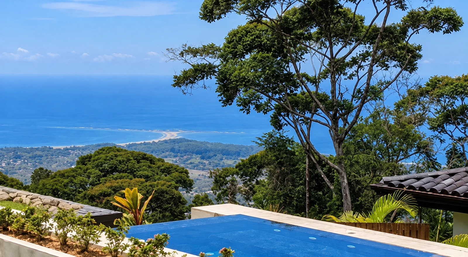 Infinity pool overlooking a tree-covered ridge with ocean and coastline view near Uvita, Costa Rica
